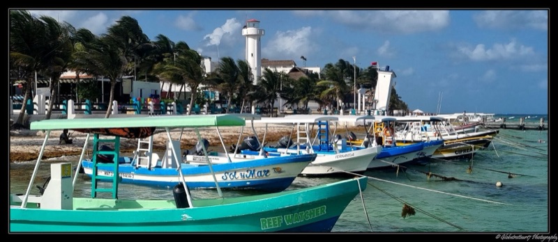 Boats and the lighthouse at Puerto Morelos, Quintana Roo